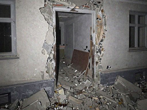AI generated image of a crime scene, depicts a damaged apartment entrance